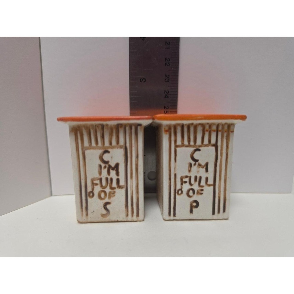 vintage, comical salt and pepper shakers feature an outhouse design with humorou